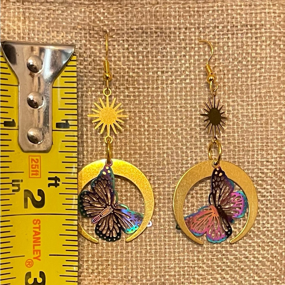 Antique gold colored earrings with iridescent butterflies.